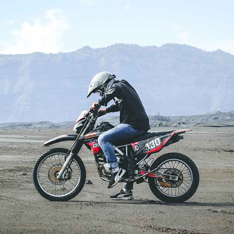 photo of a man riding a dirt bike